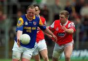 6 May 2001; Niall Sheridan of Longford is tackled by Aaron Hoey of Louth during the Bank of Ireland Leinster Senior Football Championship First Round match between Louth and Longford at Páirc Tailteann in Navan, Meath. Photo by Damien Eagers/Sportsfile