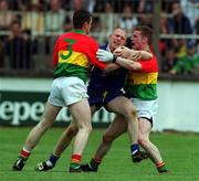 13 May 2001; Tommy Gill of Wicklow is tackled by Brian Farrell, 3, and Val Fleming of Carlow during the Bank of Ireland Leinster Senior Football Championship First Round match between Carlow and Wicklow at St Conleth's Park in Newbridge, Kildare. Photo by Matt Browne/Sportsfile