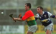 29 April 2001; Johnny Nevin of Carolw in action against Cyril Cuddy of Laois during the Guinness Leinster Senior Hurling Championship Preliminary Round match between Carlow and Laois at Dr Cullen Park in Carlow. Photo by Damien Eagers/Sportsfile