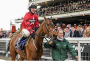 16 March 2016; Jockey Ryan Hatch and stable hand Fay Shelton celebrate as they return to the winners enclosure after winning the RSA Steeple Chase with Blaklion. Prestbury Park, Cheltenham, Gloucestershire, England. Picture credit: Seb Daly / SPORTSFILE