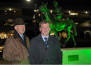 16 March 2016; The Arkle and Dawn Run, pictured, Statues were lit green ahead of St Patrick’s Day to mark Arkle’s 50th and Dawn Run’s 30th anniversary of winning the Gold Cup. Pictured infront of the Dawn Run statue are trainer Willie Mullins, left, and his brother Tony Mullins, from Gorn, Co. Kilkenny. Prestbury Park, Cheltenham, Gloucestershire, England. Picture credit: Seb Daly / SPORTSFILE