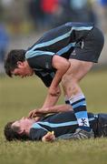 3 March 2010; Castletroy's Alex De Souza assists team-mate Michael Dooley as he lies on the pitch during the game. Avonmore Munster Rugby Schools Senior Cup Semi-Final, Rockwell v Castletroy College, Clanwilliam Park, Tipperary Town, Tipperary. Picture credit: Diarmuid Greene / SPORTSFILE
