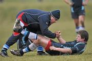 3 March 2010; Castletroy's Michael Dooley is helped to his feet by Physio Dave Cross. Avonmore Munster Rugby Schools Senior Cup Semi-Final, Rockwell v Castletroy College, Clanwilliam Park, Tipperary Town, Tipperary. Picture credit: Diarmuid Greene / SPORTSFILE