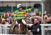 18 March 2016; Barry Geraghty acknowledges the crowd as he is led down in front of the grandstand after winning the JCB Triumph Hurdle on Ivanovich Gorbatov. Prestbury Park, Cheltenham, Gloucestershire, England. Picture credit: Seb Daly / SPORTSFILE