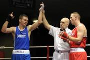 19 February 2010; Luke Keeler, Crumlin, blue, is announced victorios over Andrew Jennings, St Matthews, red, following their 75kg bout. National Mens and Womens Elite National Boxing Championships, Preliminary Rounds, National Stadium, Dublin. Picture credit: Stephen McCarthy / SPORTSFILE
