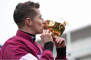 18 March 2016; Bryan Cooper kisses the Gold Cup after winning the Timico Cheltenham Gold Cup Steeple Chase on Don Cossack. Prestbury Park, Cheltenham, Gloucestershire, England. Picture credit: Cody Glenn / SPORTSFILE