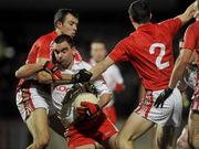 13 March 2010; Ryan McMenamin, Tyrone, in action against Paul O'Flynn and Ray Carey, Cork. Allianz GAA Football National League, Division 1, Round 4, Tyrone v Cork, Healy Park, Omagh, Co. Tyrone. Picture credit: Oliver McVeigh / SPORTSFILE