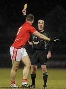 13 March 2010; Referee, David Coldrick, issues Michael Shields, Cork, with a yellow card. Allianz GAA Football National League, Division 1, Round 4, Tyrone v Cork, Healy Park, Omagh, Co. Tyrone. Picture credit: Oliver McVeigh / SPORTSFILE