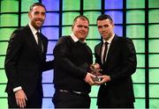 20 March 2016; Mark Duffy, Special Olympics Ireland, is presented with the 3 FAI Football for All International Player of the Year award by Republic of Ireland Internationals Richard Keogh and Seamus Coleman. 3 FAI International Soccer Awards. RTE, Donnybrook, Dublin. Picture credit: David Maher / SPORTSFILE