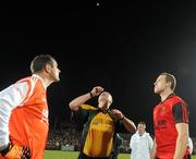 20 March 2010; Armagh captain Stephen McDonnell, left, and Down captain Ambrose Rodgers, right, watch as referee Martin Sludden tosses the coin. Allianz National Football League, Down v Armagh, Division 2, Round 5, Pairc Esler, Newry, Co. Down. Picture credit: Oliver McVeigh / SPORTSFILE