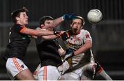 26 March 2016; Niall Grimley, left, Armagh, with support from team-mate Aaron Findon, centre, scores his side's first goal in the final moments of the game to level the scores, despite the attention of Colm Cavanagh, right, Tyrone. Allianz Football League, Division 2, Round 6, Tyrone v Armagh, Healy Park, Omagh, Co. Tyrone. Photo by Sportsfile