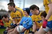 27 March 2016; Ryan Dunleavy, who celebrates his 7th birthday tomorrow, Monday, and is a cousin of the Kilbride players on the Roscommon team, with the Roscommon team as they leave the team bench having had their team photogtraph taken. Allianz Football League Division 1 Round 6, Roscommon v Mayo. Dr Hyde Park, Roscommon.  Picture credit: Brendan Moran / SPORTSFILE