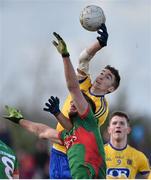 27 March 2016; Cathal Compton, Roscommon, gets his hand to the ball ahead of Aidan O'Shea, Mayo. Allianz Football League Division 1 Round 6, Roscommon v Mayo. Dr Hyde Park, Roscommon.  Picture credit: Brendan Moran / SPORTSFILE