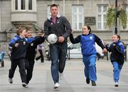 25 March 2010; Dublin footballer Éamon Fennell with pupils of Gaelscoil Bharra, Cabra, from left, Ross Butler, Chris Maher, Doireann Byrne Ryan, and Grace Keogh, all age 10, at the launch of the Naomh Fionn Barra Easter Camps, which take place from the 6th - 9th April, at John Paul Park (The Bogies), Cabra. For more information you can contact Amy on 01-8686209. Stephen's Green, Dublin. Picture credit: Brian Lawless / SPORTSFILE