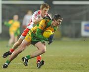 30 January 2010; Leo McLoone, Donegal, in action Niall McKenna, Tyrone. Barrett Sports Lighting Dr. McKenna Cup Final, Donegal v Tyrone, Brewster Park, Enniskillen, Co. Fermanagh. Picture credit: Oliver McVeigh / SPORTSFILE *** Local Caption ***