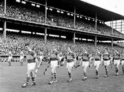 5 September 1965; The Tipperary captain Jimmy Doyle leads the Tipperary and Wexford teams during the parade ahead of the game. All Ireland Senior Hurling Championship Final, Tipperary v Wexford, Croke Park, Dublin. Picture credit; Connolly Collection / SPORTSFILE