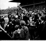 5 September 1965; Tipperary's Jimmy Doyle holds the Liam MacCarthy Cup as he is held aloft by Tipperary supporters after his side's vitory over Wexford. All Ireland Senior Hurling Championship Final, Tipperary v Wexford, Croke Park, Dublin. Picture credit; Connolly Collection / SPORTSFILE