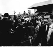 5 September 1965; Tipperary's Jimmy Doyle holds the Liam MacCarthy Cup as he is held aloft by Tipperary supporters after his side's vitory over Wexford. All Ireland Senior Hurling Championship Final, Tipperary v Wexford, Croke Park, Dublin. Picture credit; Connolly Collection / SPORTSFILE