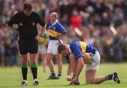 13 May 2001; Referee Michael Monahan watches as Eamon Hanrahan of Tipperary reties his laces during the Bank of Ireland Munster Senior Football Championship Quarter-Final match between Tipperary and Kerry at Clonmel Sportsfield in Clonmel, Tipperary. Photo by Brendan Moran/Sportsfile
