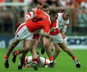 20 May 2001; Martin O'Rourke of Armagh is tackled by Brian McGuckian of Tyrone during the Bank of Ireland Ulster Senior Football Championship Quarter-Final match between Tyrone and Armagh at St Tiernach's Park in Clones, Monaghan. Photo by David Maher/Sportsfile