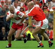 20 May 2001; Owen Mulligan of Tyrone, is tackled by Gerard Reid of Armagh during the Bank of Ireland Ulster Senior Football Championship Quarter-Final match between Tyrone and Armagh at St Tiernach's Park in Clones, Monaghan. Photo by David Maher/Sportsfile