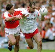 20 May 2001; Declan McCrossan of Tyrone in action against Kieran McGeeney of Armagh during the Bank of Ireland Ulster Senior Football Championship Quarter-Final match between Tyrone and Armagh at St Tiernach's Park in Clones, Monaghan. Photo by David Maher/Sportsfile