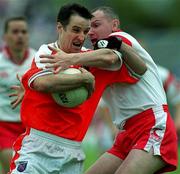 20 May 2001; Barry O'Hagan of Armagh is tackled by Chris Lann of Tyrone during the Bank of Ireland Ulster Senior Football Championship Quarter-Final match between Tyrone and Armagh at St Tiernach's Park in Clones, Monaghan. Photo by Damien Eagers/Sportsfile