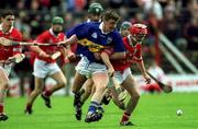 15 April 2001; Noel Morris of Tipperary in action against Seánie McGrath of Cork during the Allianz GAA National Hurling League Division 1B Round 5 match between Tipperary and Cork at Semple Stadium in Thurles, Tipperary. Photo by Brendan Moran/Sportsfile