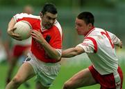 20 May 2001; Oisin McConville of Armagh is tackled by Cormac McGinley of Tyrone during the Bank of Ireland Ulster Senior Football Championship Quarter-Final match between Tyrone and Armagh at St Tiernach's Park in Clones, Monaghan. Photo by David Maher/Sportsfile