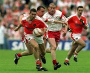 20 May 2001; Diarmaid Marsden of Armagh is tackled by Pascal Canavan of Tyrone during the Bank of Ireland Ulster Senior Football Championship Quarter-Final match between Tyrone and Armagh at St Tiernach's Park in Clones, Monaghan. Photo by David Maher/Sportsfile