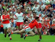 20 May 2001; Brian Dooher of Tyrone in action against Kieran Hughes of Armagh during the Bank of Ireland Ulster Senior Football Championship Quarter-Final match between Tyrone and Armagh at St Tiernach's Park in Clones, Monaghan. Photo by David Maher/Sportsfile