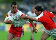 20 May 2001; Brian McGuigan of Tyrone is tackled by Kieran McGeeney of Armagh during the Bank of Ireland Ulster Senior Football Championship Quarter-Final match between Tyrone and Armagh at St Tiernach's Park in Clones, Monaghan. Photo by Damien Eagers/Sportsfile
