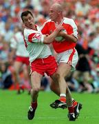 20 May 2001; Ger Reid of Armagh is tackled by Eoin Gormley of Tyrone during the Bank of Ireland Ulster Senior Football Championship Quarter-Final match between Tyrone and Armagh at St Tiernach's Park in Clones, Monaghan. Photo by Damien Eagers/Sportsfile
