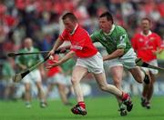 27 May 2001; John O'Mahony of Cork is tackled by PJ Garvey of Limerick during the Guinness Munster Senior Hurling Championship Quarter-Final match between Cork and Limerick at Páirc Uí Chaoimh in Cork. Photo by Ray McManus/Sportsfile