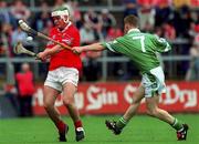 27 May 2001; Niall McCarthy of Cprk is tackled by Damien Browne of Limerick during the Guinness Munster Senior Hurling Championship Quarter-Final match between Cork and Limerick at Páirc Uí Chaoimh in Cork. Photo by Ray McManus/Sportsfile