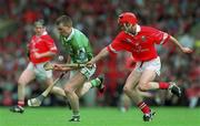 27 May 2001; Mark Foley of Limerick clears under pressure from Sean McGrath of Cork during the Guinness Munster Senior Hurling Championship Quarter-Final match between Cork and Limerick at Páirc Uí Chaoimh in Cork. Photo by Ray McManus/Sportsfile