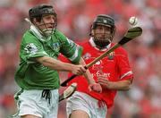 27 May 2001; Jack Foley of Limerick races goalwards ahead of Ben O'Connor of Cork during the Guinness Munster Senior Hurling Championship Quarter-Final match between Cork and Limerick at Páirc Uí Chaoimh in Cork. Photo by Ray McManus/Sportsfile