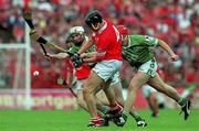 27 May 2001; John Browne of Cork is tackled by Paul O'Grady, left, and team-mate Ollie Moran of Limerick during the Guinness Munster Senior Hurling Championship Quarter-Final match between Cork and Limerick at Páirc Uí Chaoimh in Cork. Photo by Ray McManus/Sportsfile