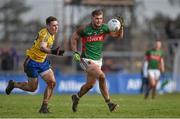 27 March 2016; Aidan O'Shea, Mayo, solos away from John McManus, Roscommon. Allianz Football League Division 1 Round 6, Roscommon v Mayo. Dr Hyde Park, Roscommon.  Picture credit: Brendan Moran / SPORTSFILE