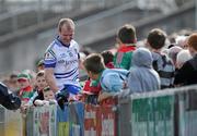 28 March 2010; Monaghan's Dick Clerkin finds himself amongst Mayo fans after his momentum took him over the advertising hoardings. Allianz GAA Football National League, Division 1, Round 6, Mayo v Monaghan, McHale Park, Castlebar, Co. Mayo. Picture credit: Brian Lawless / SPORTSFILE
