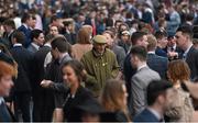 6 April 2016; A punter makes his way through the crowd. Leopardstown, Co. Dublin. Picture credit: David Fitzgerald / SPORTSFILE