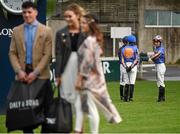 6 April 2016; Jockeys watch on as winner of the best dressed competition, Thomas O'Brien, from Firhouse, Co. Dublin, and Florence Sherry, from Lusk, Co. Dublin, have their photo taken. Leopardstown, Co. Dublin. Picture credit: David Fitzgerald / SPORTSFILE