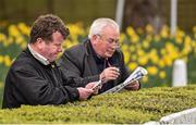 10 April 2016; Punters study their racecards. Leopardstown, Co. Dublin. Picture credit: Cody Glenn / SPORTSFILE