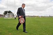 18 April 2010; Martin Skelly, Vice-Chairman of the Leinster Council, arrives with the Walsh Shield, a few minutes into the first half. Allianz GAA Hurling National League, Division 2, Round 7, Carlow v Laois, Dr Cullen Park, Carlow. Picture credit: Brian Lawless / SPORTSFILE
