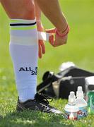 3 April 2010; A player tapes up her socks before the game. TG4 Ladies All-Star Football Exhibition game, 2009 All Stars team v 2008 All Stars, TG4 Ladies Football All-Star Tour, Pairc na nGael, Treasure Island, San Francisco, California, USA. Picture credit: Brendan Moran / SPORTSFILE