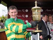 22 April 2010; Jockey John Thomas McNamara lifts the La Touche Cup after victory in the Avon Ri Corporate & Leisure Resort Steeplechaseon on L'Ami. Punchestown Racing Festival, Punchestown, Co. Kildare. Picture credit: Matt Browne / SPORTSFILE