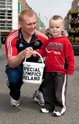 23 April 2010; Special Olympics Ireland All-Ireland Collection Day took place all across Ireland today. Munster rugby star Keith Earls gets a donation from three year-old Nathan Broderick in O'Connell Street, Limerick, to show their support for Special Olympics Ireland. This is the biggest annual fundraising event in aid of Special Olympics Ireland and thousands of volunteers took to the streets to help raise much needed funds. Fire Brigade, Debenhams, Limerick. Picture credit: Kieran Clancy / SPORTSFILE