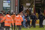 15 April 2016; Members of An Garda siochana stand move supporters from both  Shamrock Rovers and Bohemians off the pitch. SSE Airtricity League, Premier Division, Bohemians v Shamrock Rovers. Dalymount Park, Dublin. Picture credit: David Maher / SPORTSFILE