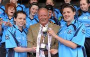 24 April 2010; Pat Quill, President of the Ladies Gaelic Football Association presenting the cup to Eureka SS joint captains Grainne Mackin, right, and Megan O'Brien. Tesco All-Ireland Junior B Post Primary Schools Final, Eureka SS, Kells v St Paul’s, Bessbook, Armagh, Gaelic Grounds, Drogheda, Co. Louth. Photo by Sportsfile