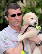 29 April 2010; Current Ipswich Town manager and former Republic of Ireland international Roy Keane with 8 week old puppy Verna at the official launch of the eighth annual Irish Guide Dogs for the Blind Specsavers Shades 2010 campaign. The campaign raises funds for the training of guide and assistant dogs and centres around a week of fundraising nationwide which kicks off on Monday May 3rd. Mount Herbert Hotel, Herbert Road, Sandymount, Dublin. Picture credit: Pat Murphy / SPORTSFILE